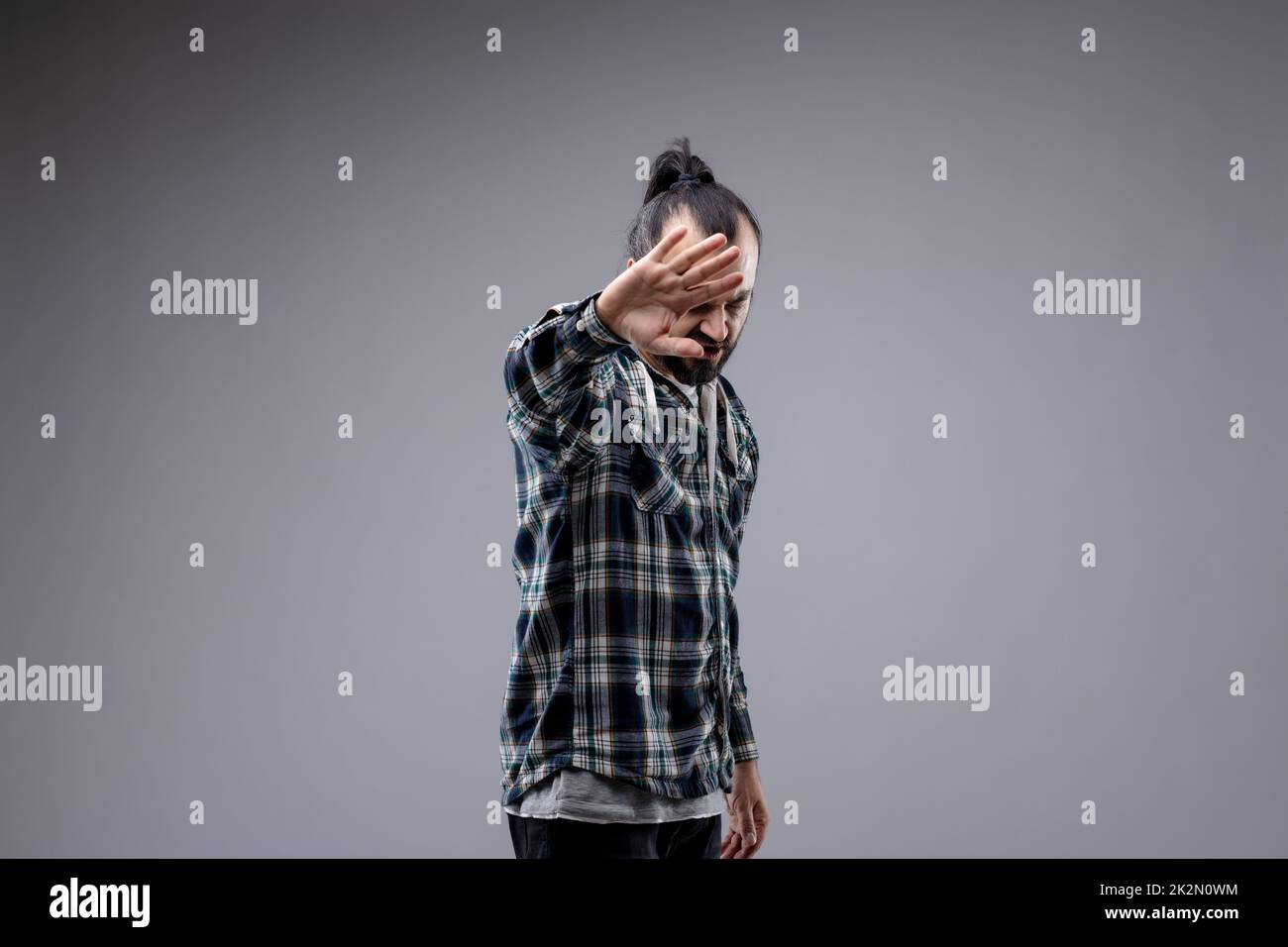 Fed up man holding up his hand in a stop gesture Stock Photo