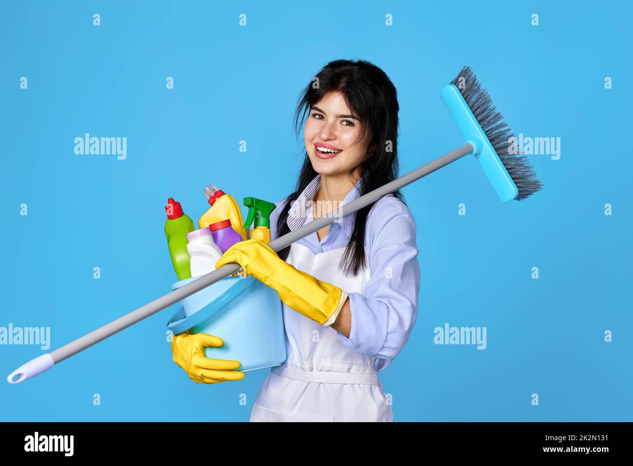 woman in gloves holding bucket of detergents and broom Stock Photo - Alamy
