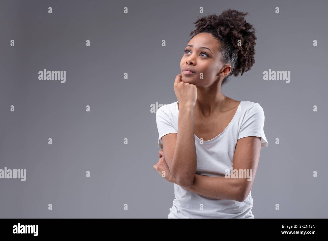Pretty thoughtful young African woman Stock Photo