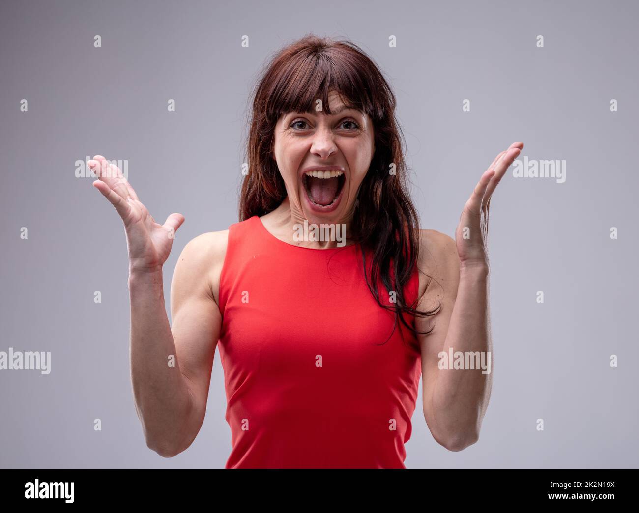 Surprised enthusiastic woman cheering Stock Photo