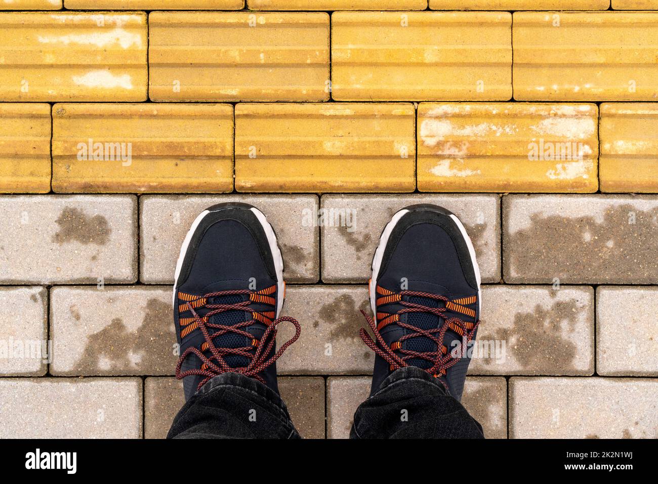 Man standing at the tactile paving Stock Photo