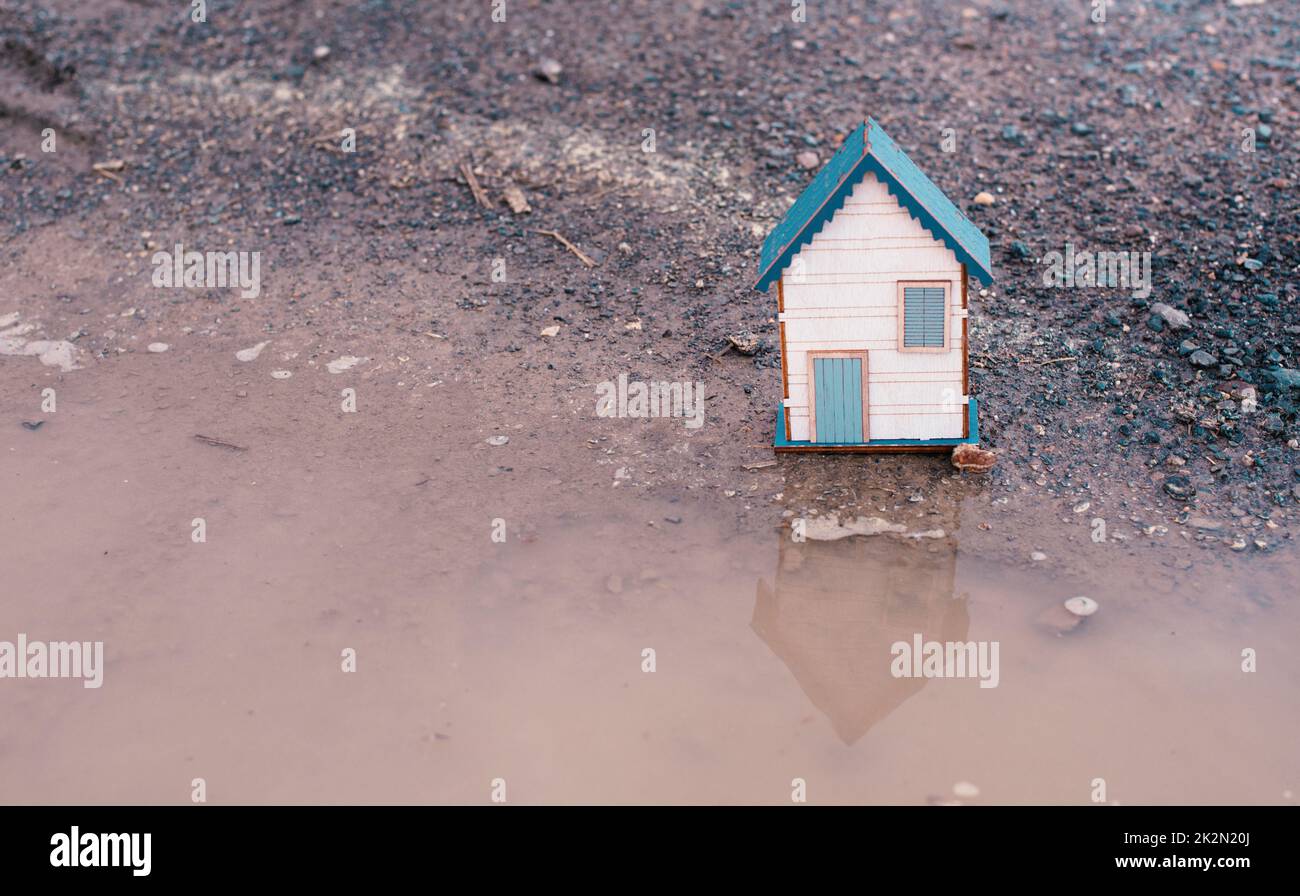 Small house standing on a road, real estate concept, renting or buying a home, travel and vacation symbol Stock Photo