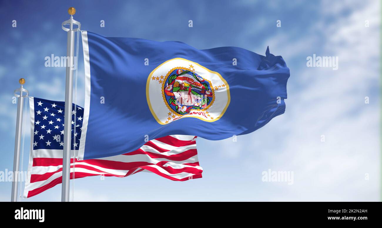 The Minnesota state flag waving along with the national flag of the United States of America Stock Photo
