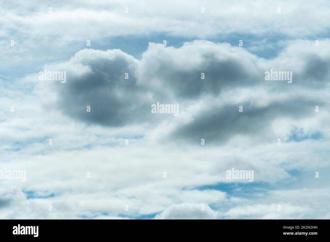 White and gray fluffy clouds on blue sky. Soft touch feeling like cotton. White puffy cloudscape. Beauty in nature. Close-up white clouds texture background. Cloudy sky. Background for tranquility. Stock Photo