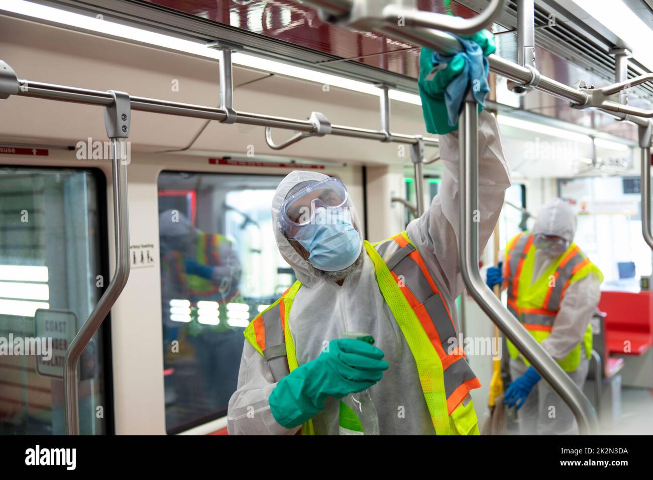 Male transit worker sanitizing subway handles Stock Photo Alamy