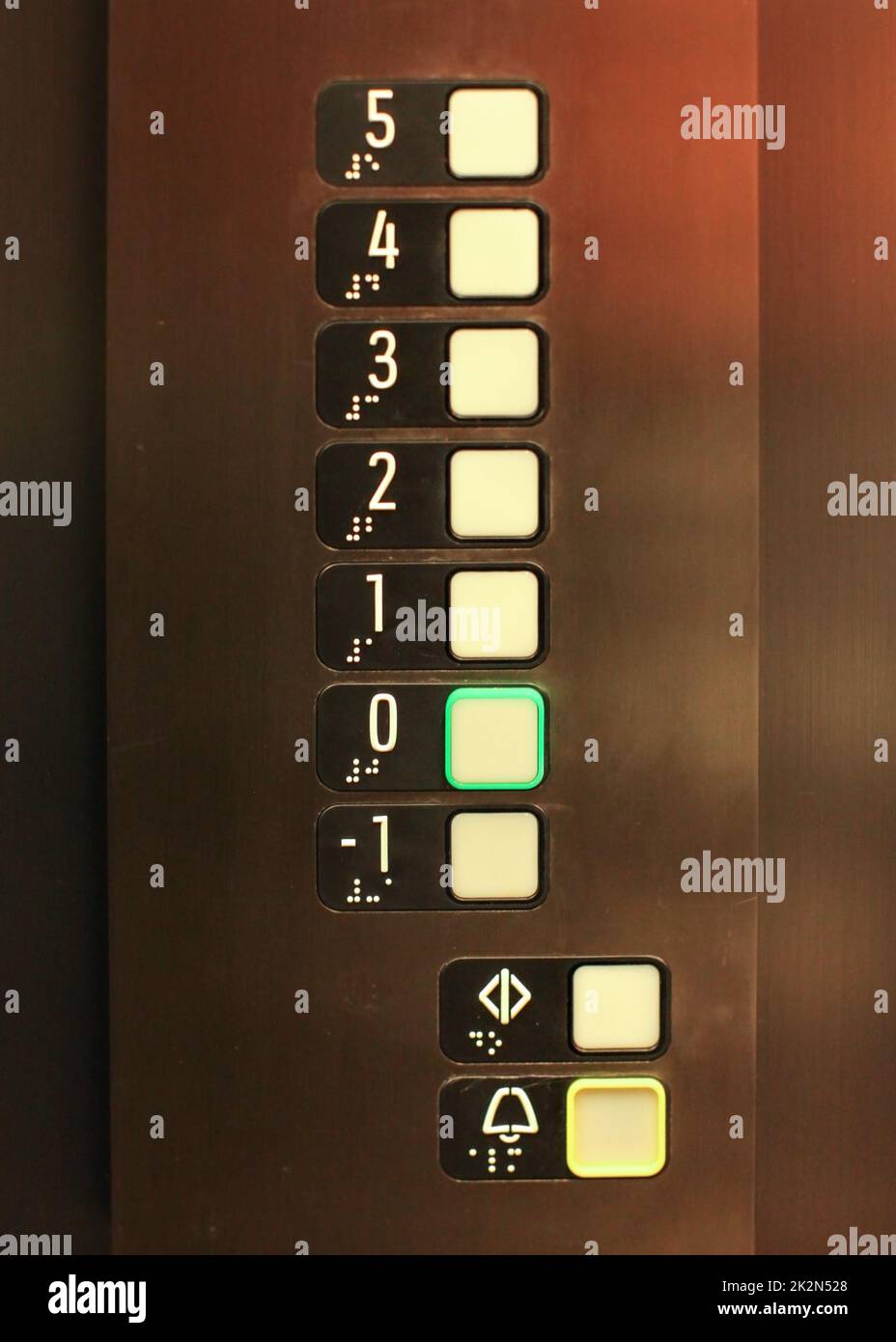 Elevator buttons, number 0 in green, blind, text in Braille alphabet under numbers, for blind disabled people. Stock Photo