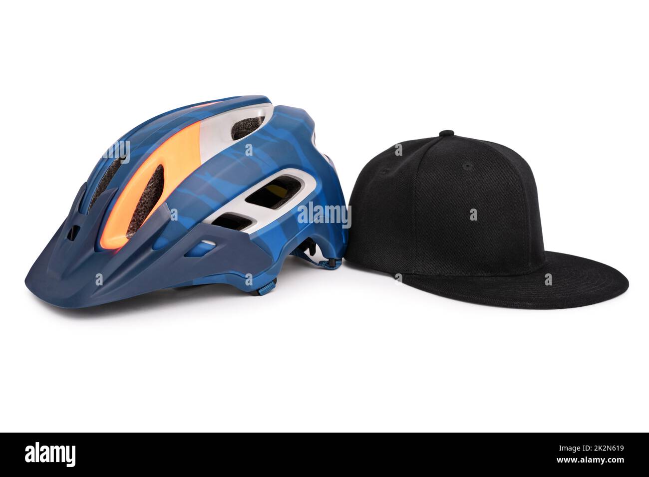 Bike helmet and a baseball snapback hat side by side Stock Photo