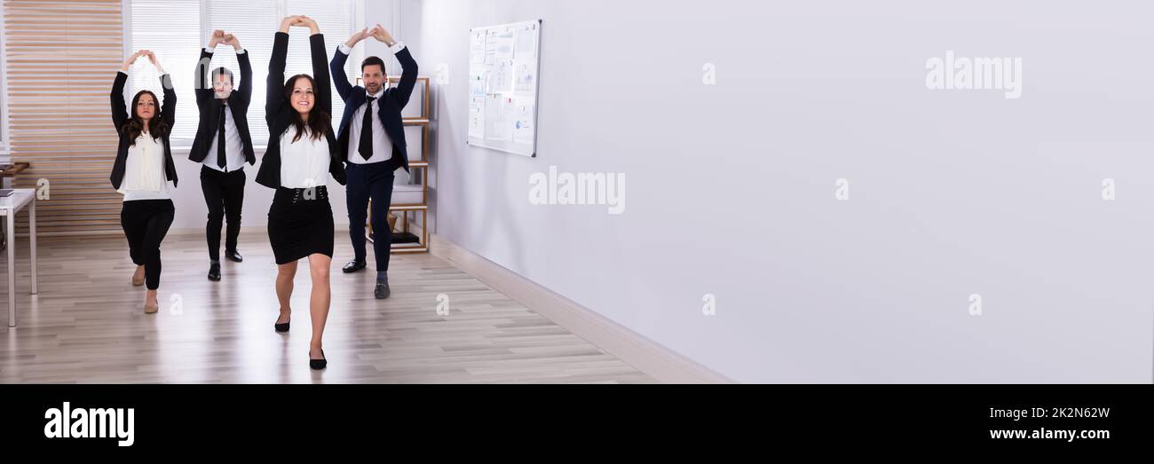 Businesspeople Doing Stretching Exercise Stock Photo