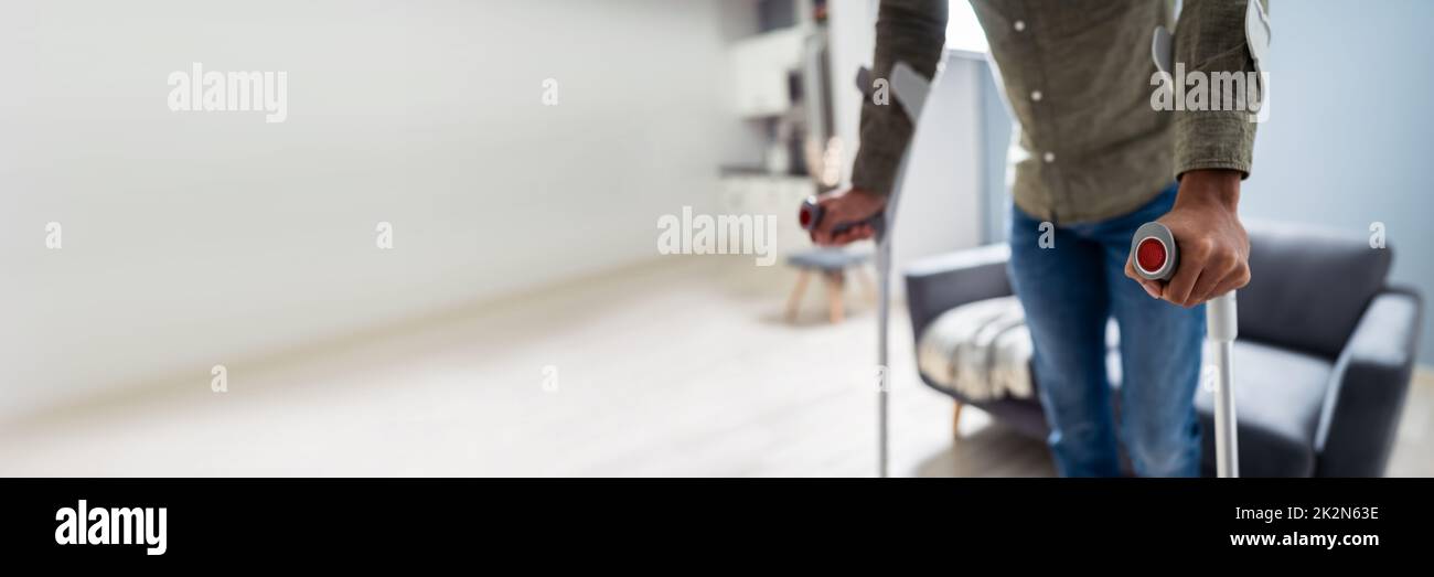 Man With Broken Leg Walking On Carpet Stock Photo