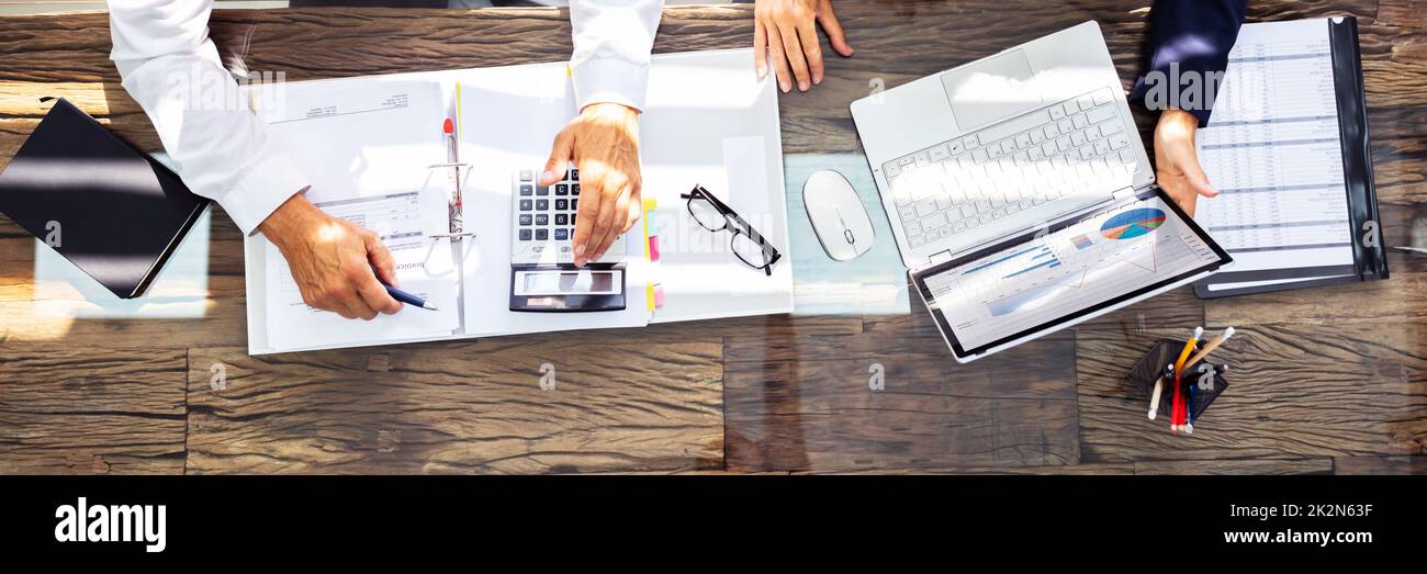 Businesspeople Using Laptop In Office Stock Photo