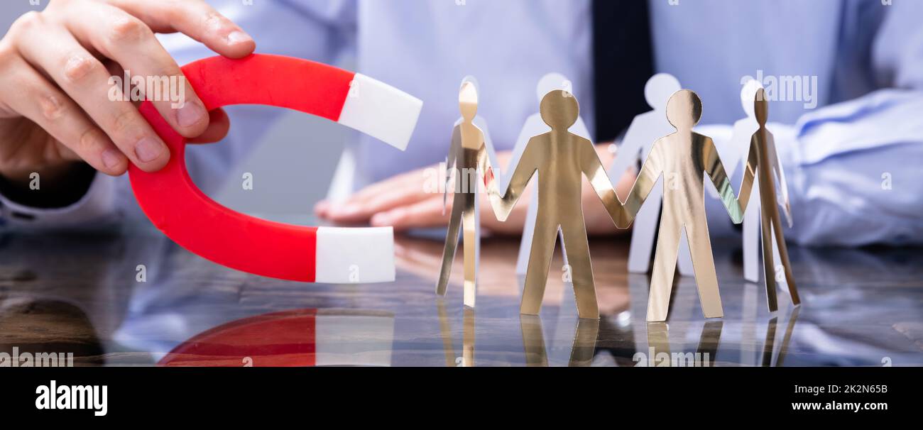 Businessperson Attracting Leads With Horseshoe Magnet Stock Photo