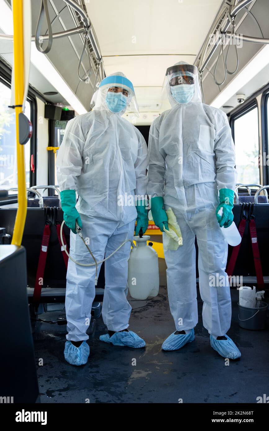 Portrait cleaning crew in clean suits sanitizing public bus Stock Photo Alamy