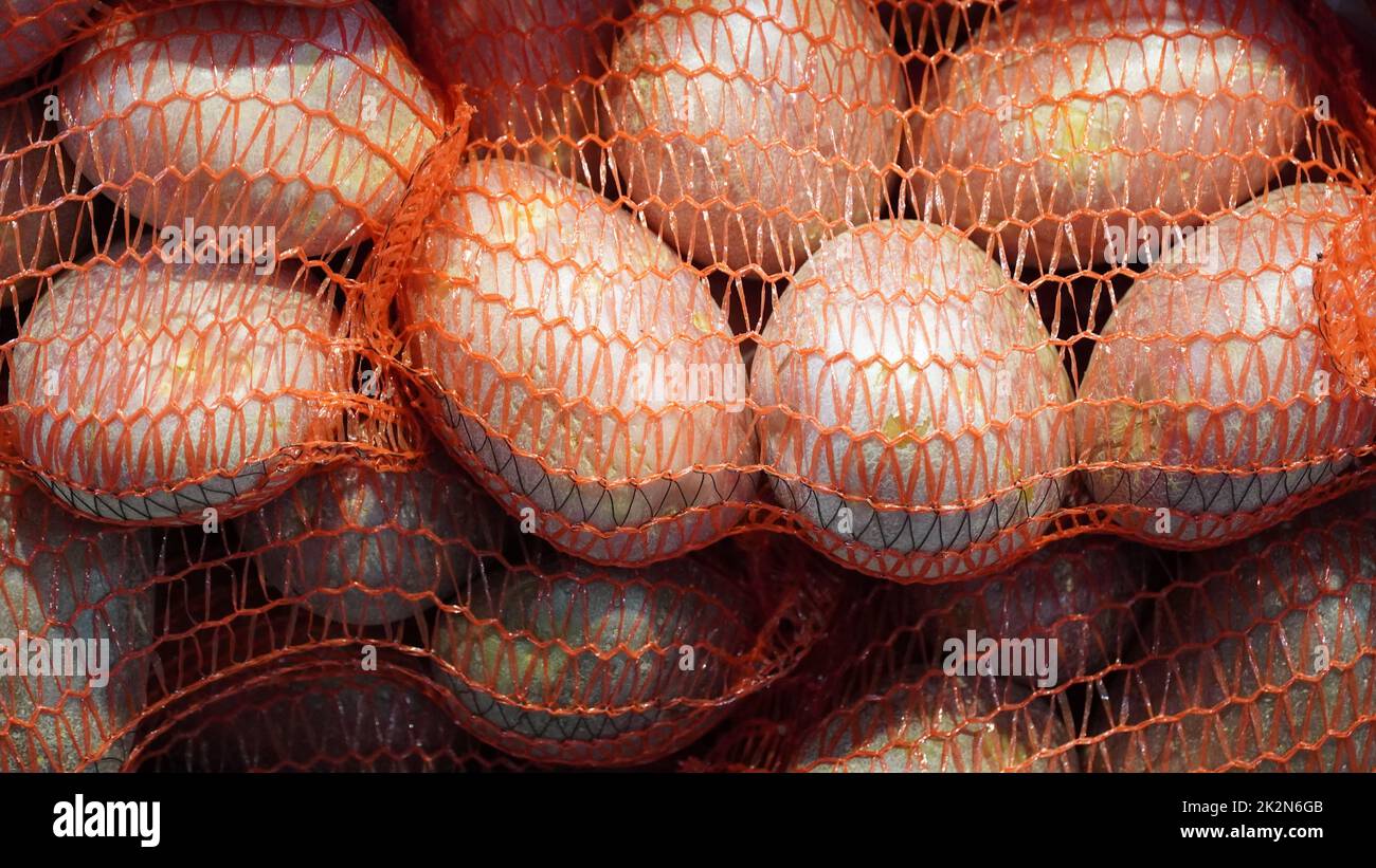 Potatoes in red string bag hi-res stock photography and images - Alamy
