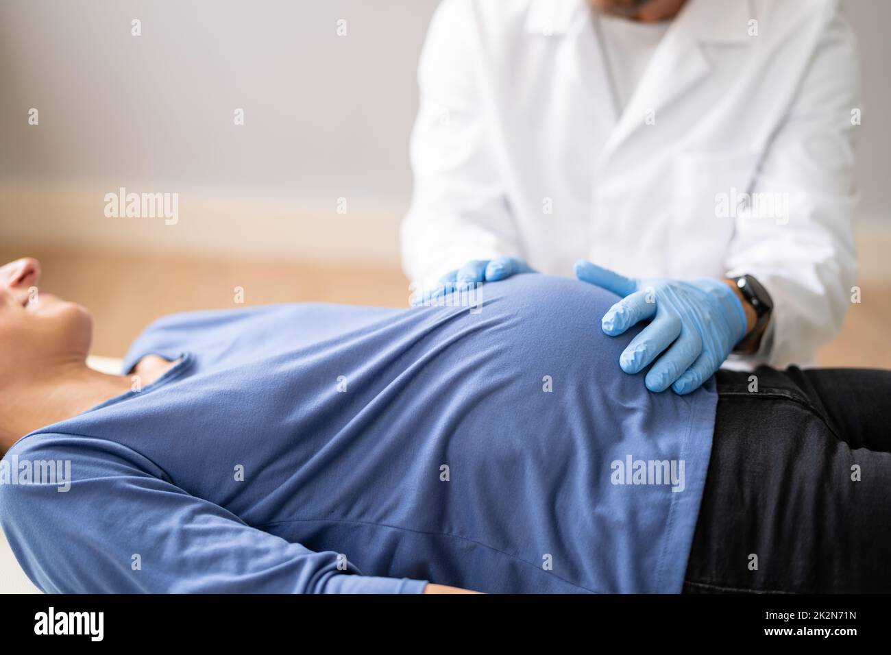 Pregnant Woman At Chiropractor. Baby Breech Physiotherapy Stock Photo