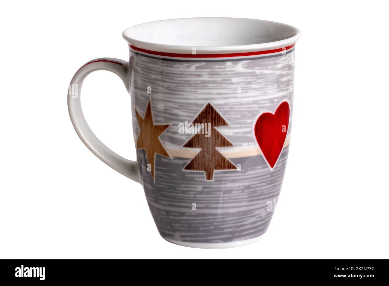 Closeup of a grey and white ceramic mug with printed Christmas motifs, such as a fir tree, star and heart isolated on a white background. Clipping path. Macro. Stock Photo