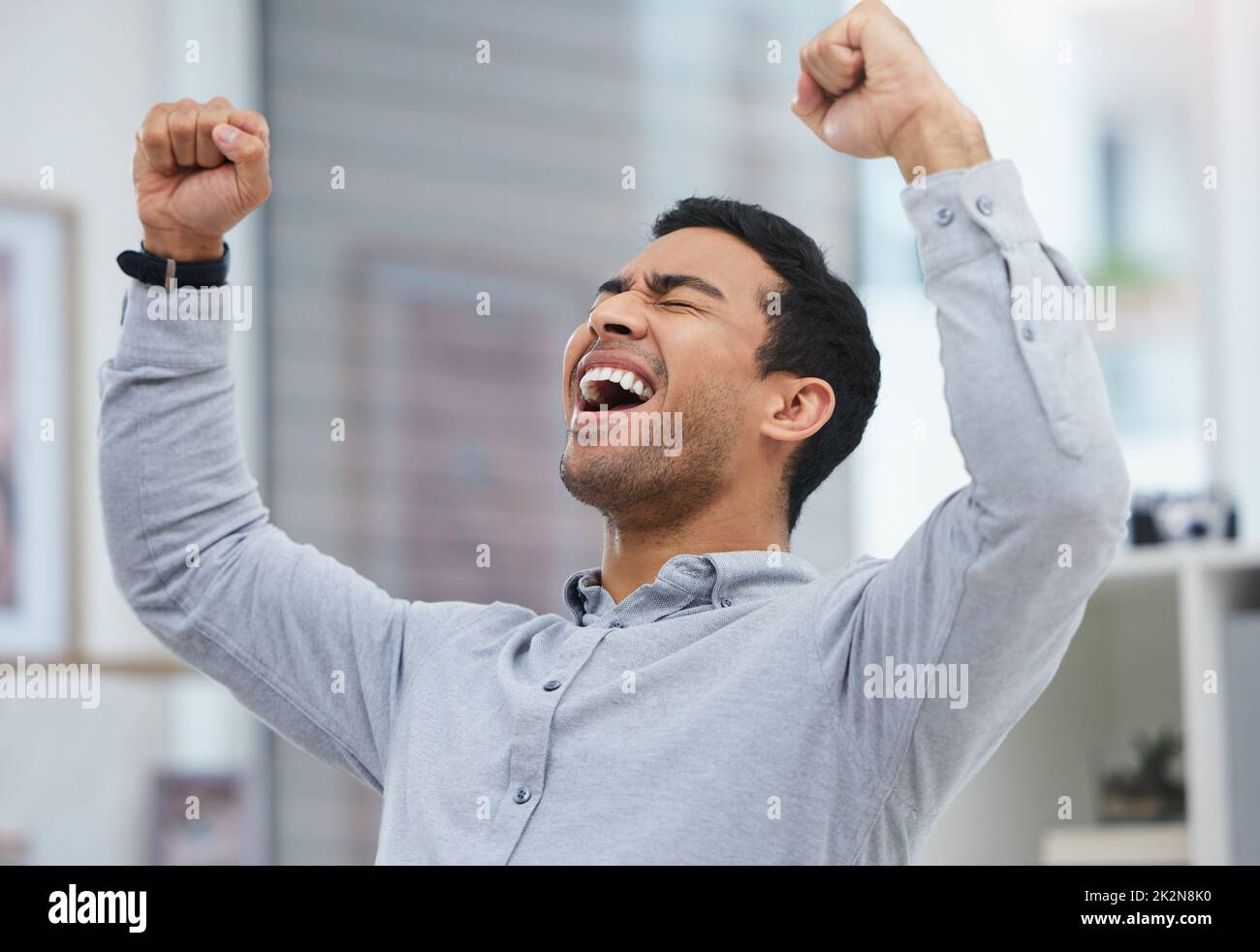 I cant wait for this fresh start. Shot of a young businessman celebrating in his office. Stock Photo