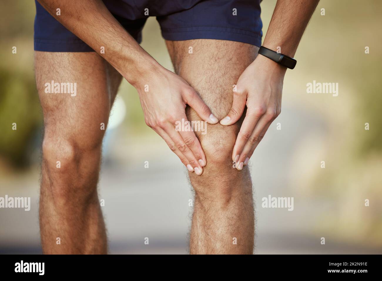 Ive reached my limit now. Closeup shot of an unrecognisable man holding his knee in pain while exercising outdoors. Stock Photo