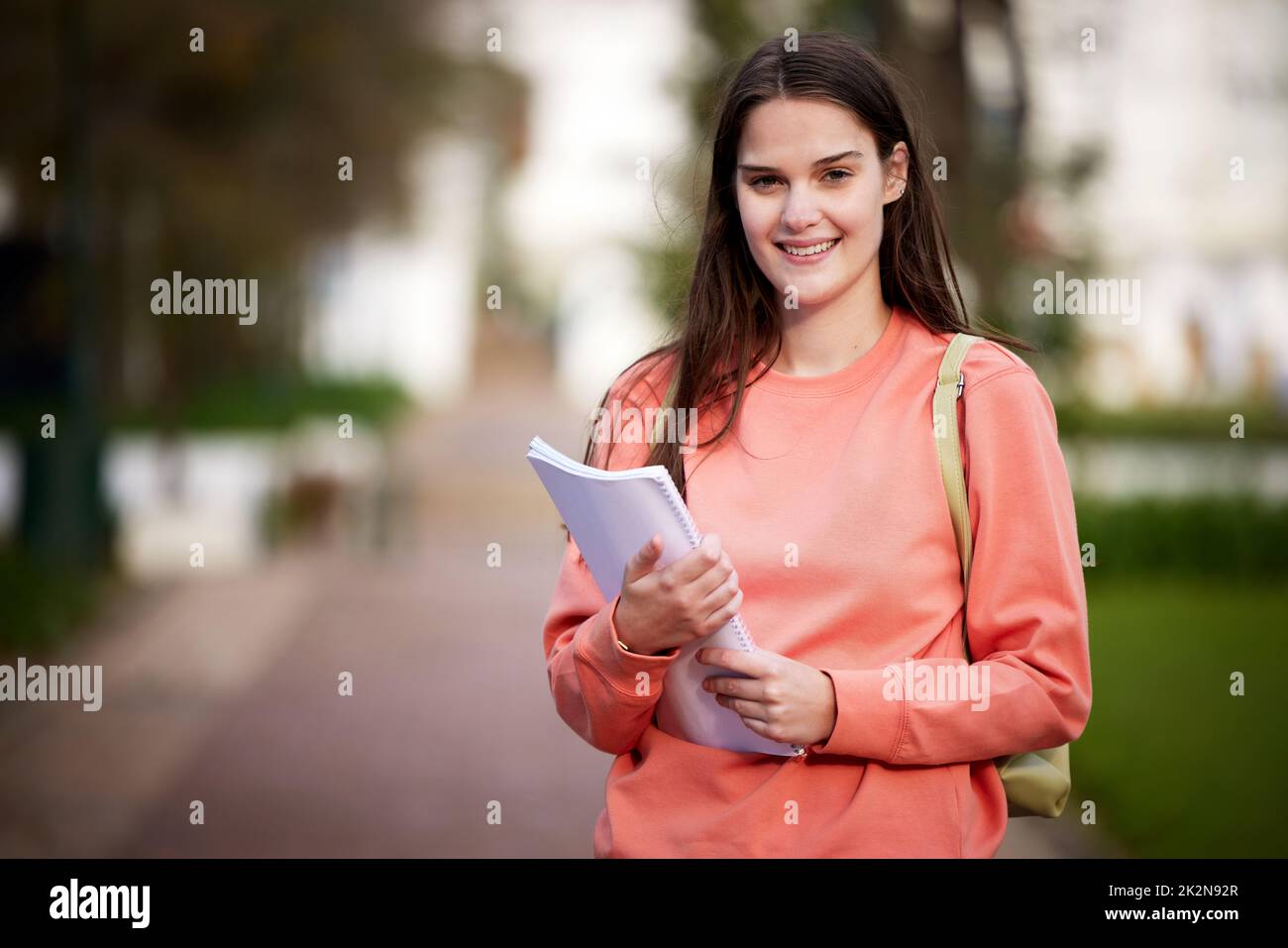 Im off to my next class. Shot of a beautiful young woman on campus. Stock Photo