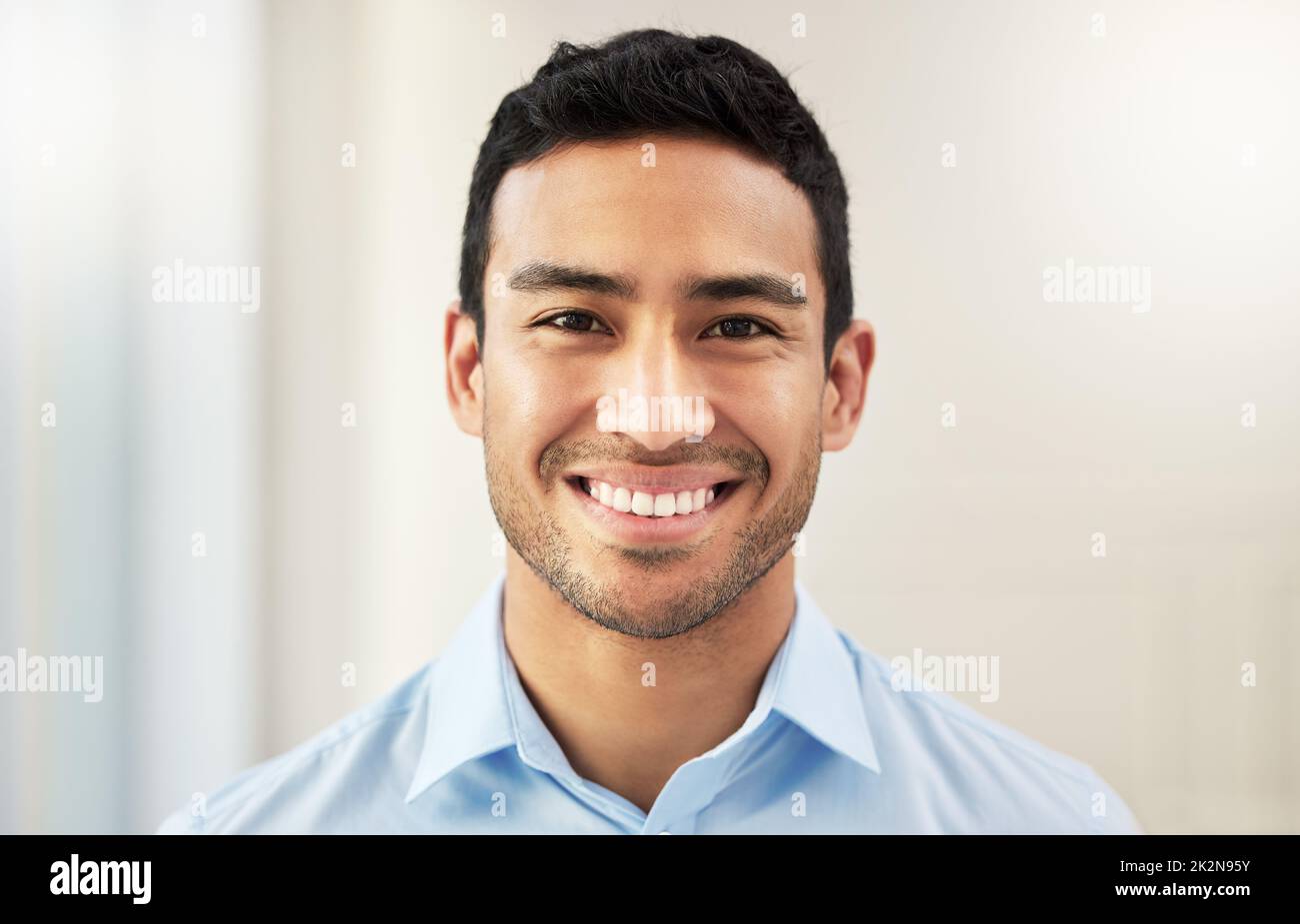 Proud of the professional goals Ive reached. Shot of a handsome young businessman in his office. Stock Photo