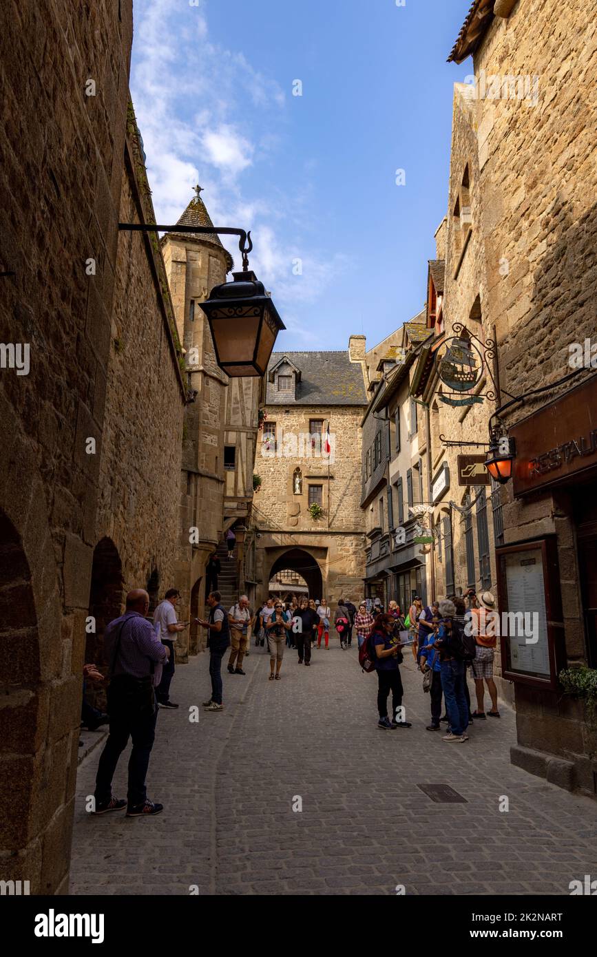 Visiting tourists in the medieval alleys on Le Mont Saint-Michel or St Michael's Mount, Avranches, Normandy, France. Stock Photo