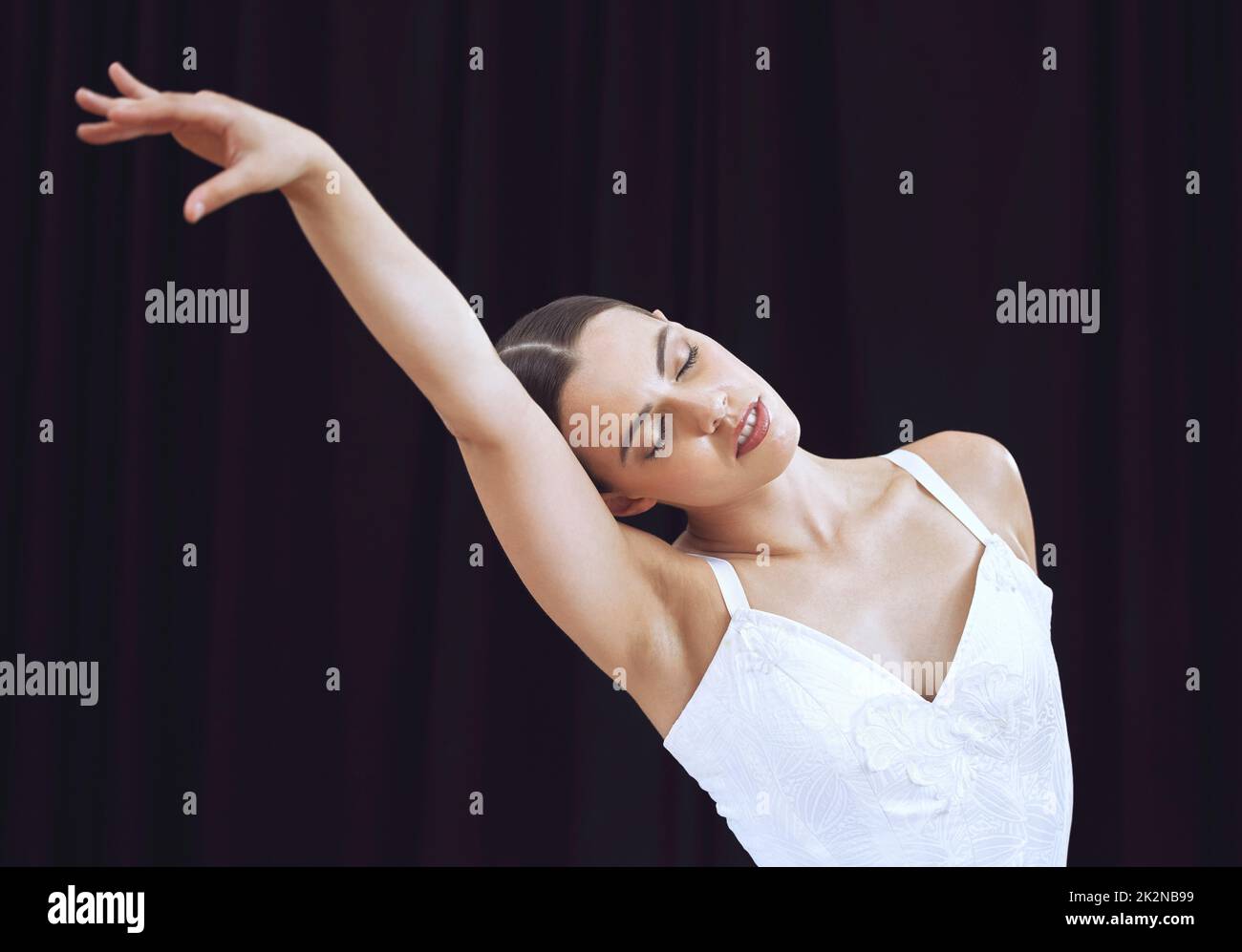 Ballet, dance and art with woman in theater performance for modern show, creative and motivation on stage. Concert, artist and dancing with ballerina Stock Photo