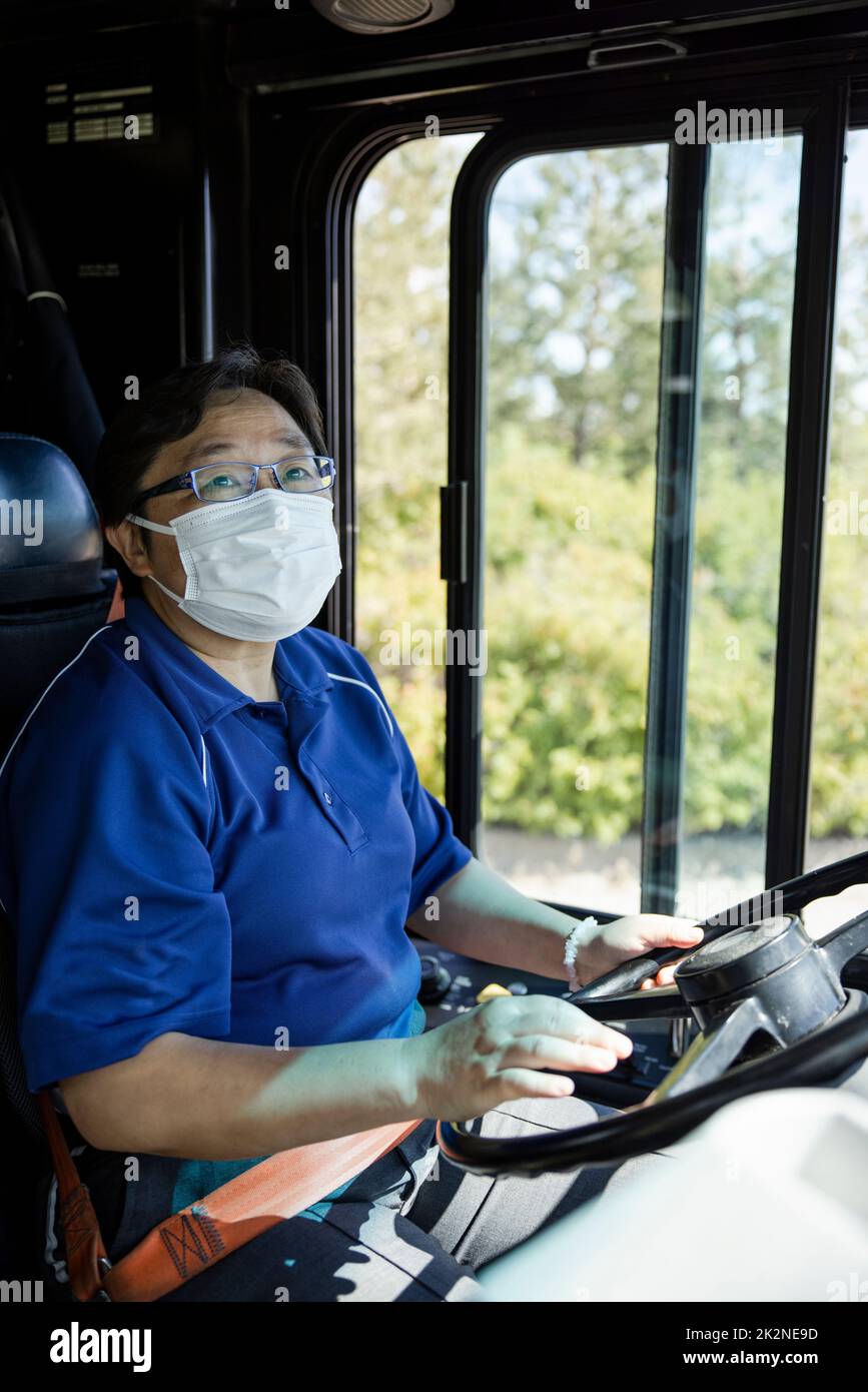 Male bus driver in face mask driving public bus Stock Photo Alamy
