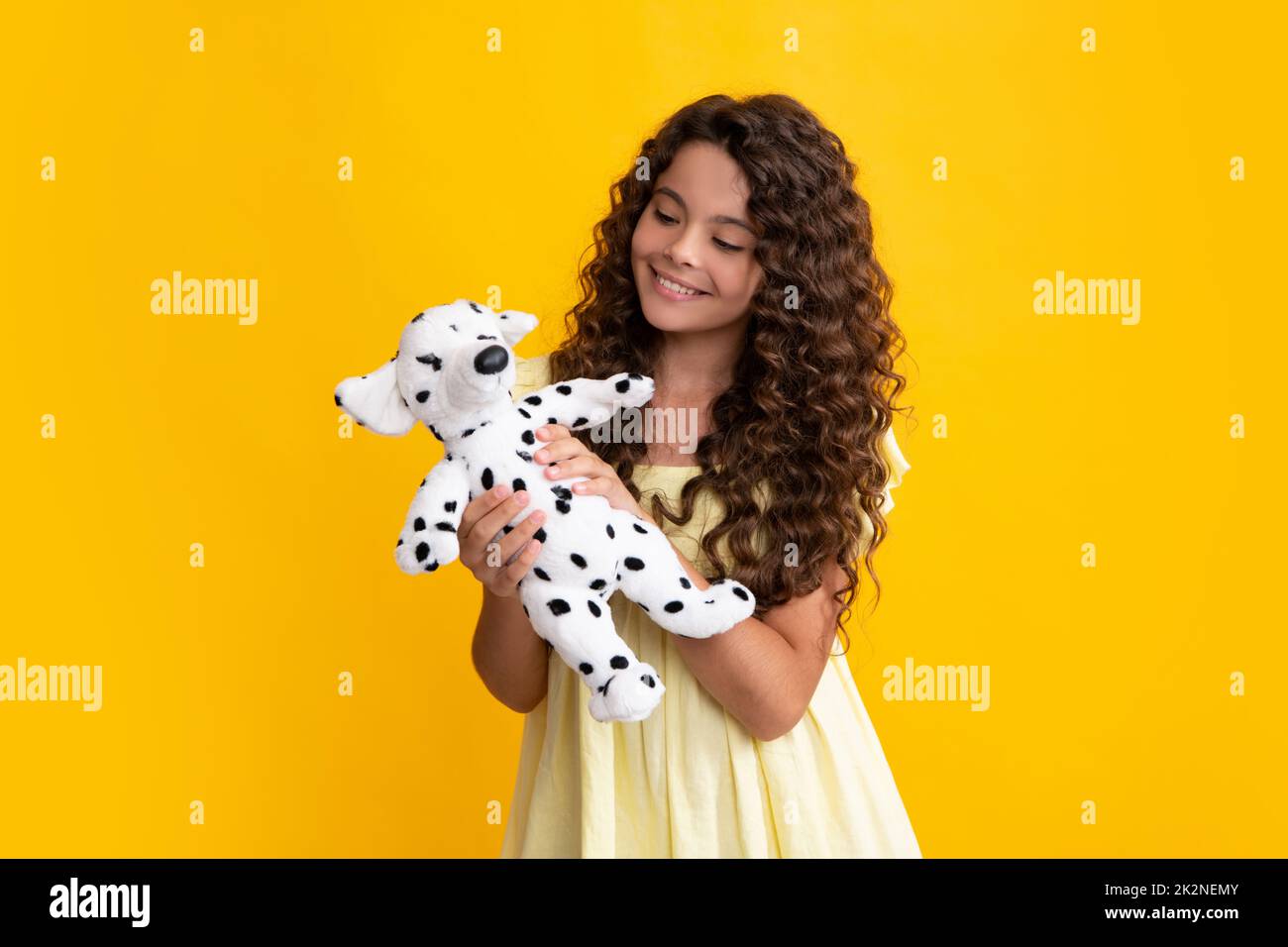 Funny teenage child hold toy. Happy childhood. Kid playing toy. Childcare concept. Happy teenager, positive and smiling emotions of teen girl. Stock Photo