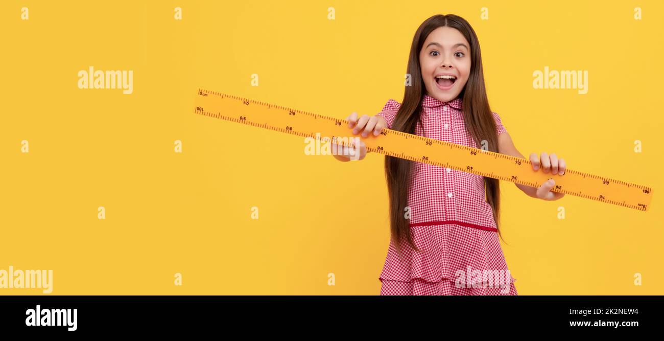 amazed teen girl hold ruler. back to school. algebra and geometry. kid study math. Banner of schoolgirl student. School child pupil portrait with copy Stock Photo