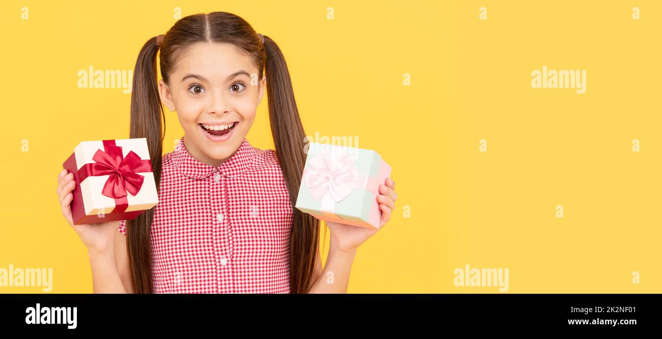 surprised kid girl hold present box for birthday, surprise. Kid girl with gift, horizontal poster. Banner header with copy space. Stock Photo