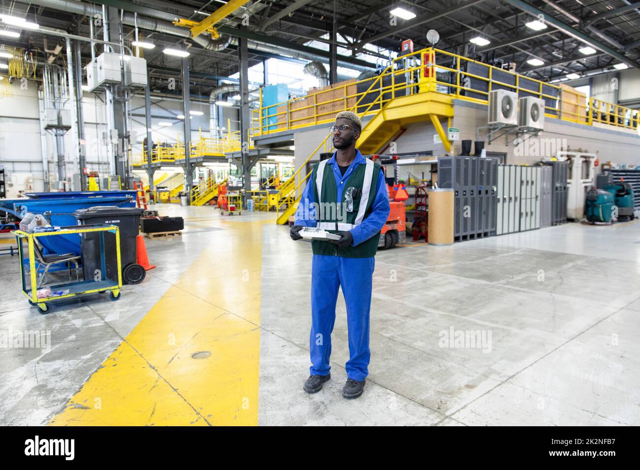 Confident male transit engineer with clipboard in maintenance facility
