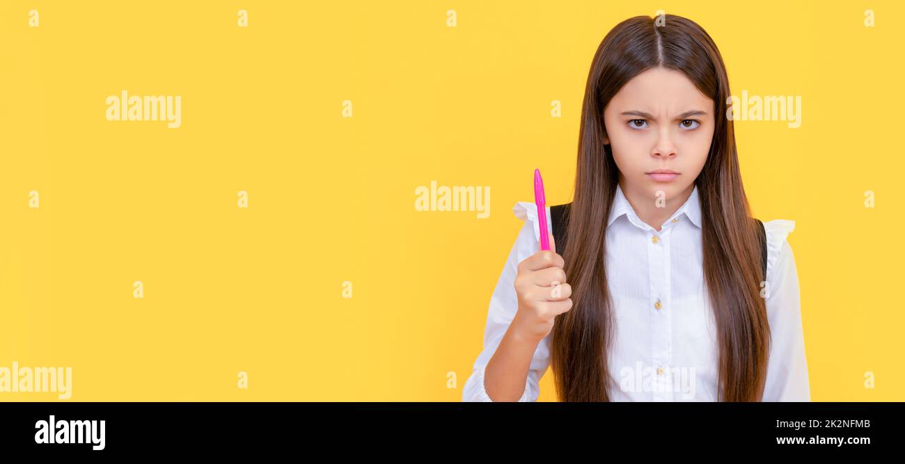 Always be serious about learning. Frown kid hold pen. School education. Keep learning better. Banner of school girl student. Schoolgirl pupil portrait Stock Photo