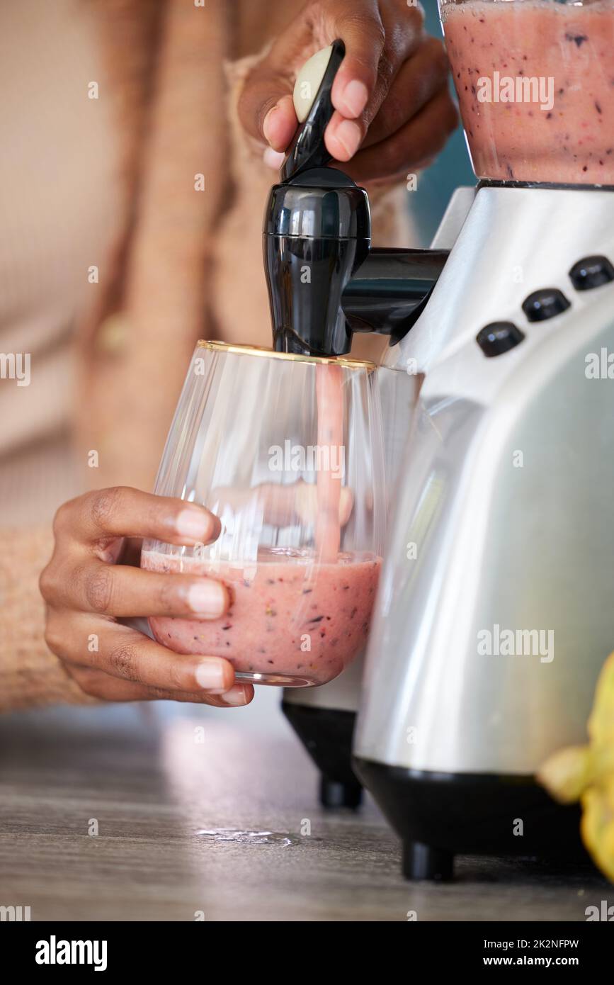 https://c8.alamy.com/comp/2K2NFPW/simply-blend-and-enjoy-closeup-shot-of-an-unrecognisable-woman-pouring-a-freshly-blended-smoothie-into-a-glass-at-home-2K2NFPW.jpg