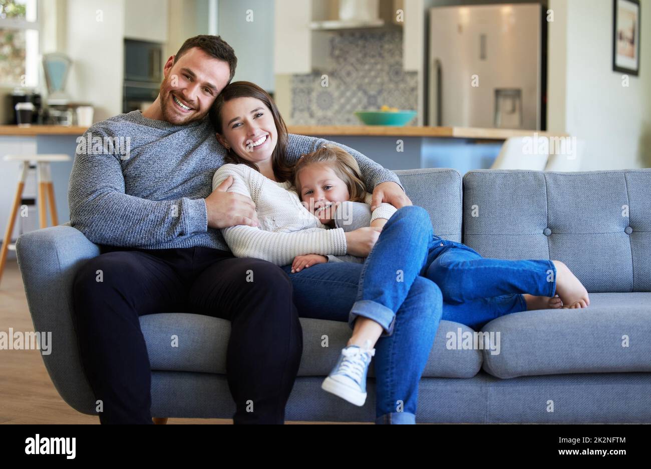 They are my source of comfort. Shot of a young family relaxing on the couch at home. Stock Photo