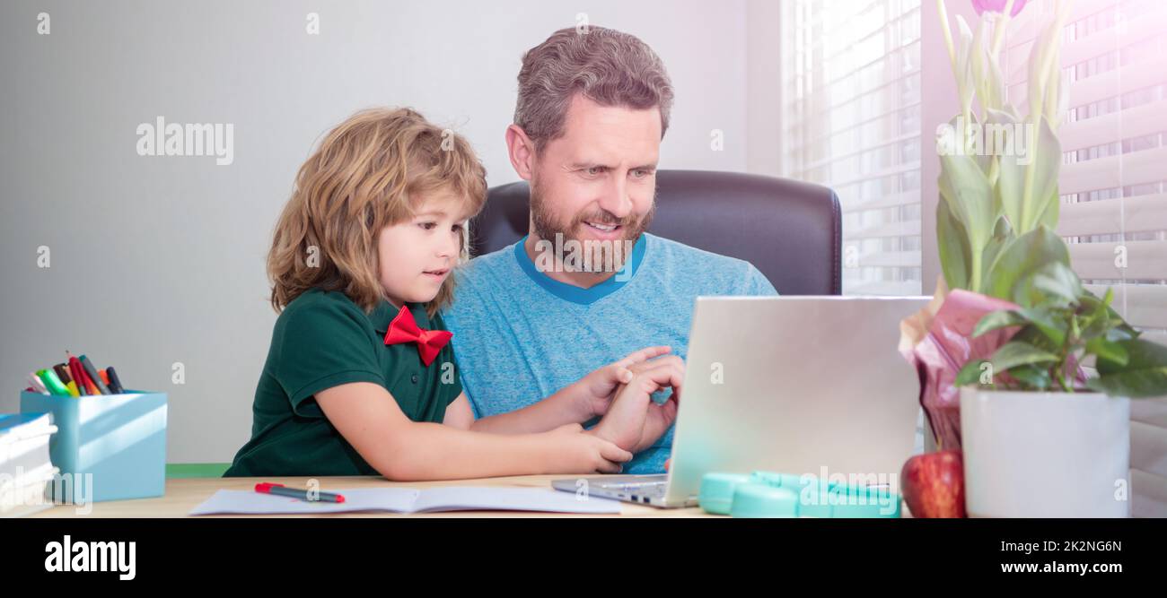 Banner of home school of father and son with laptop at home, cheerful father and son use computer at home. family blog. boy do homework with private Stock Photo