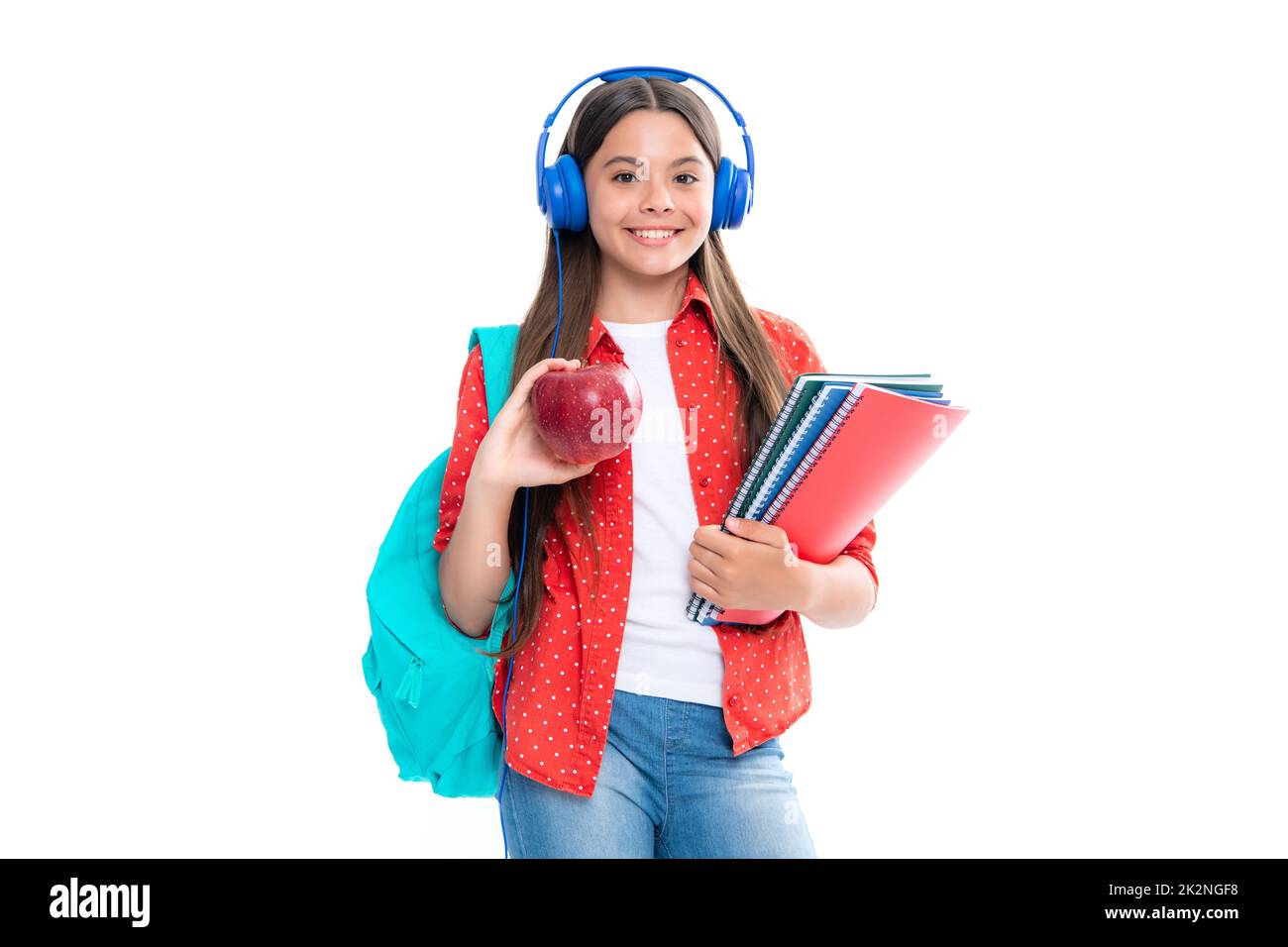 Schoolchild, teenage student girl with headphones and school bag backpack on white isolated studio background. Children school and education concept Stock Photo