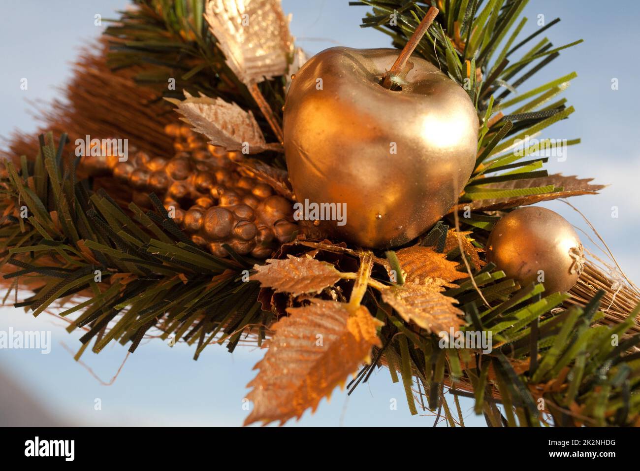 artistic decoration mady of a golden apple and green plant Stock Photo