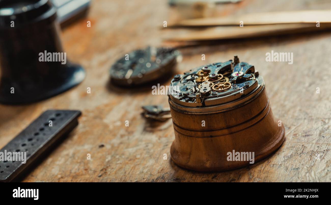 Watch mechanism mounted on a stand for repairs Stock Photo Alamy