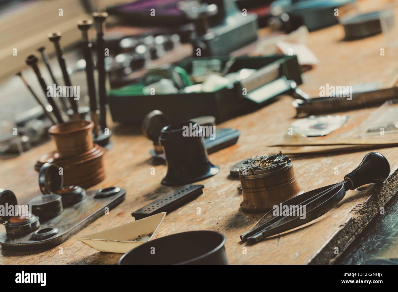 Display of a vintage watchmakers workbench with hand tools Stock Photo