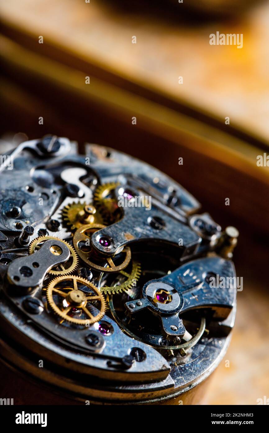 Close up on a disassembled watch or clock mechanism with gear wheels Stock Photo