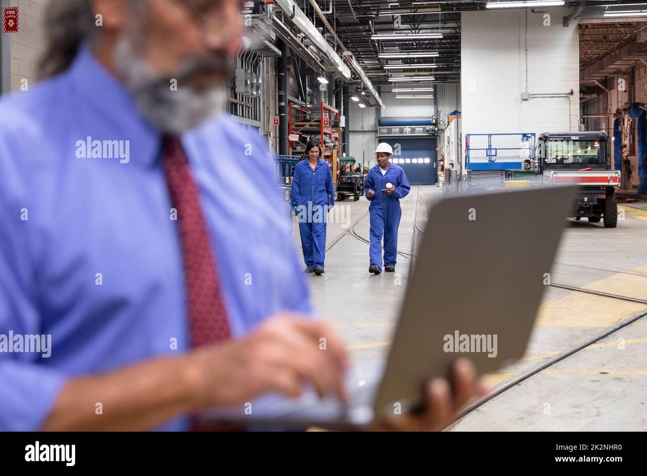 Female transit workers walking in maintenance facility Stock Photo Alamy