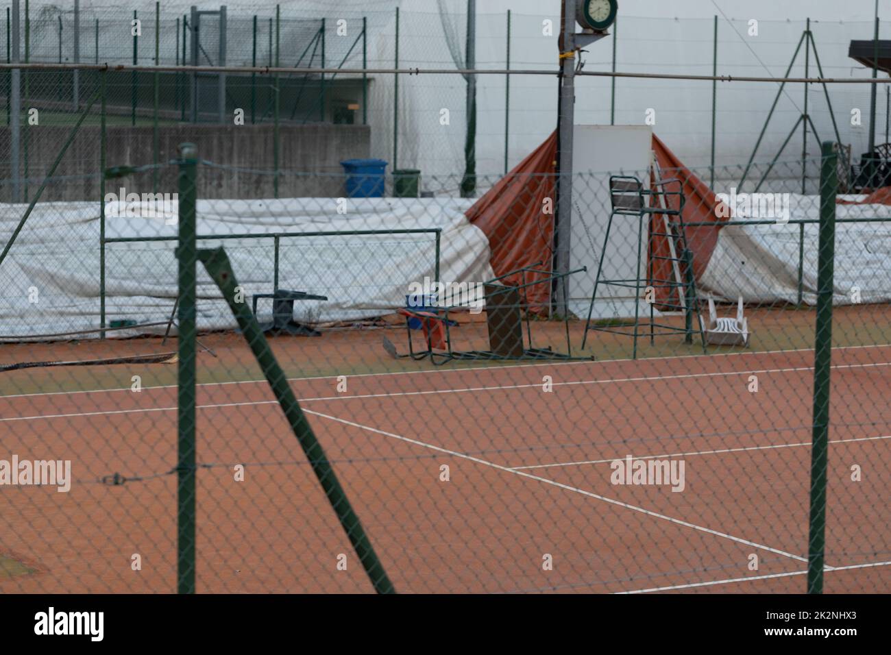 Empty all weather tennis court with umpires chair Stock Photo