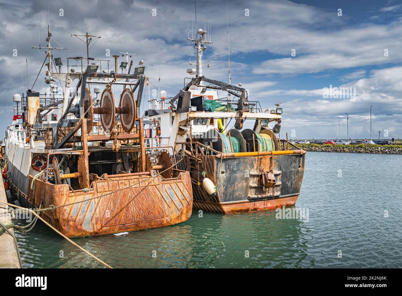 Two old and rusty fishing boats moored in Howth harbour, Dublin, Ireland Stock Photo