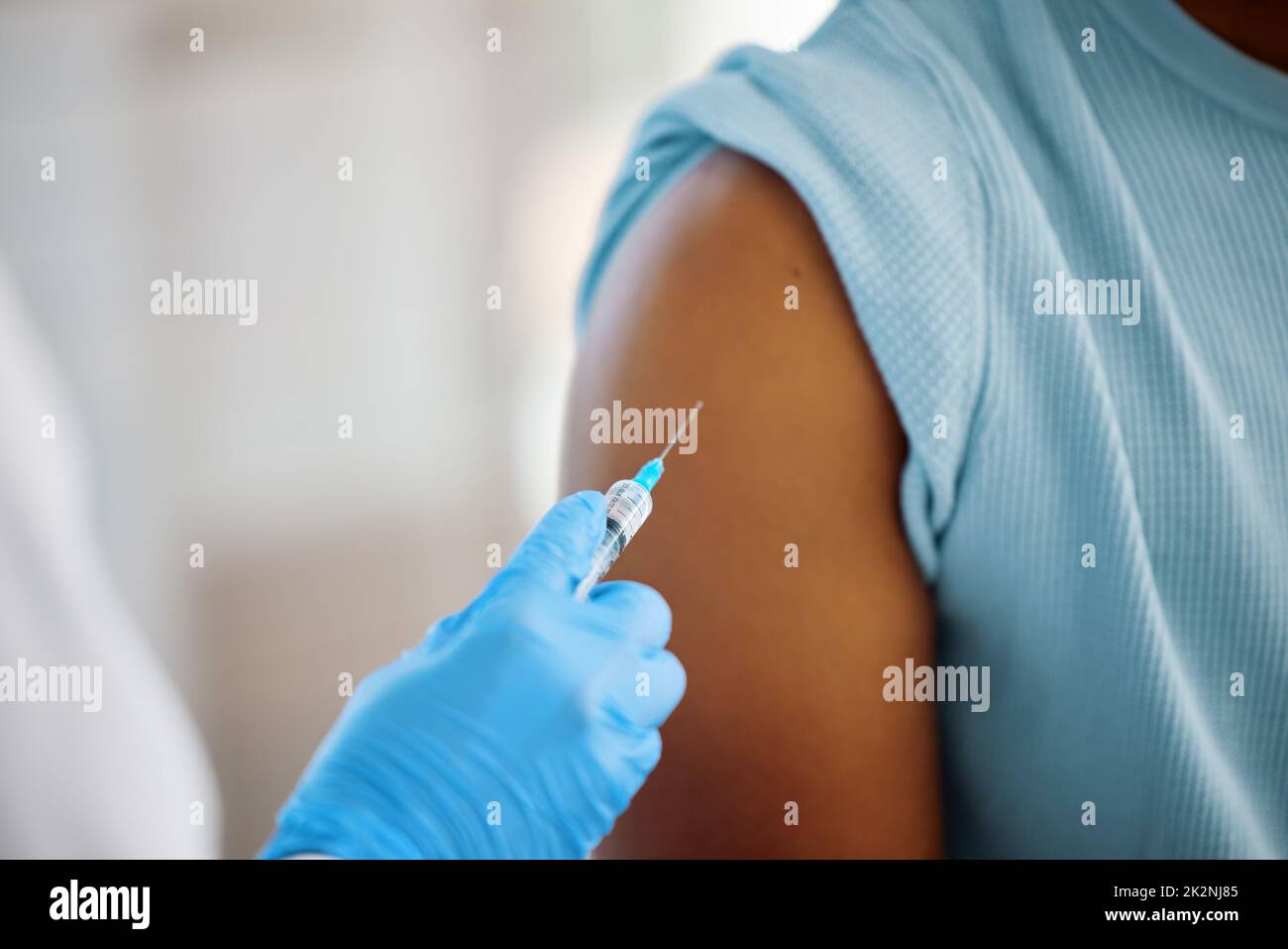 This vaccine will change my life. Shot of a doctor about to inject the arm of a patient. Stock Photo