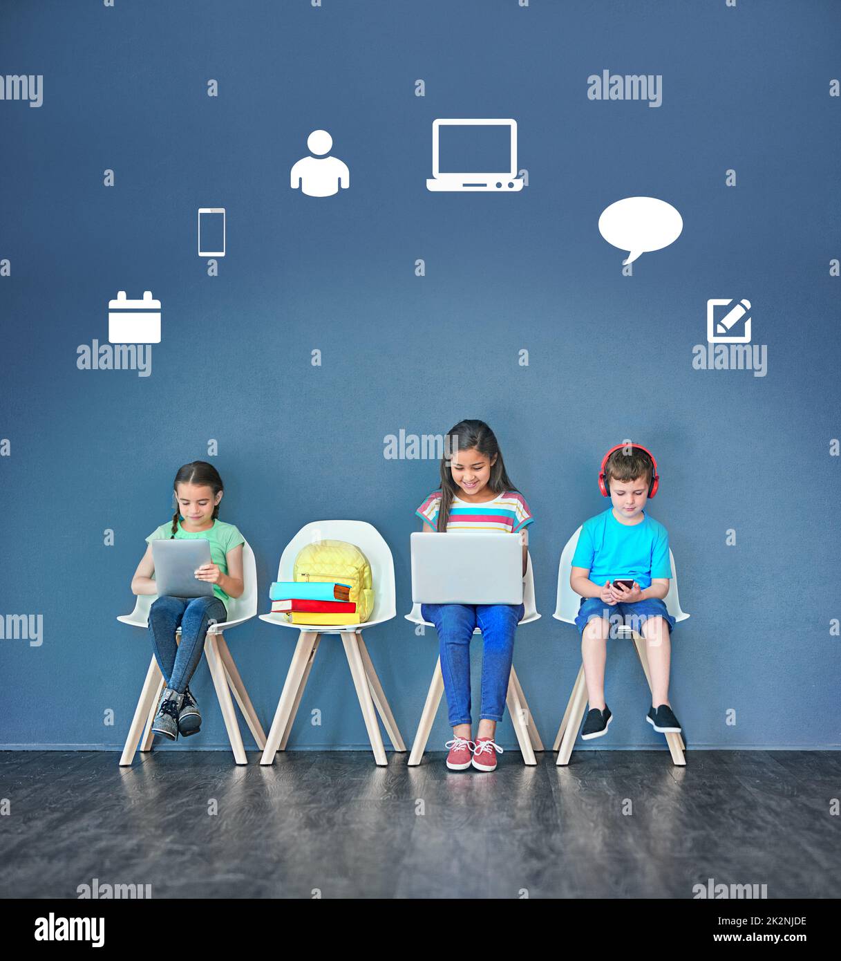 Todays child is more connected than ever before. Studio shot of kids sitting on chairs and using wireless technology with technological icons above them against a blue background. Stock Photo