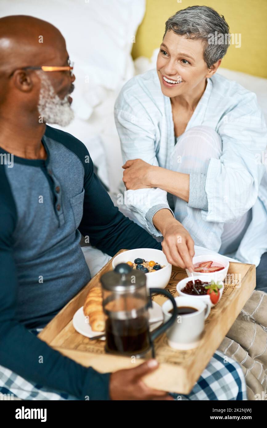 Mornings are better when we have breakfast together. Shot of a senior married couple having breakfast at home. Stock Photo