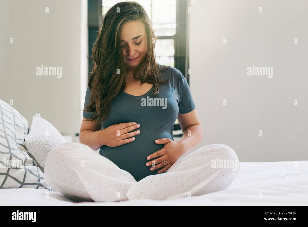 I have so much love for my unborn baby. Shot of a young pregnant woman