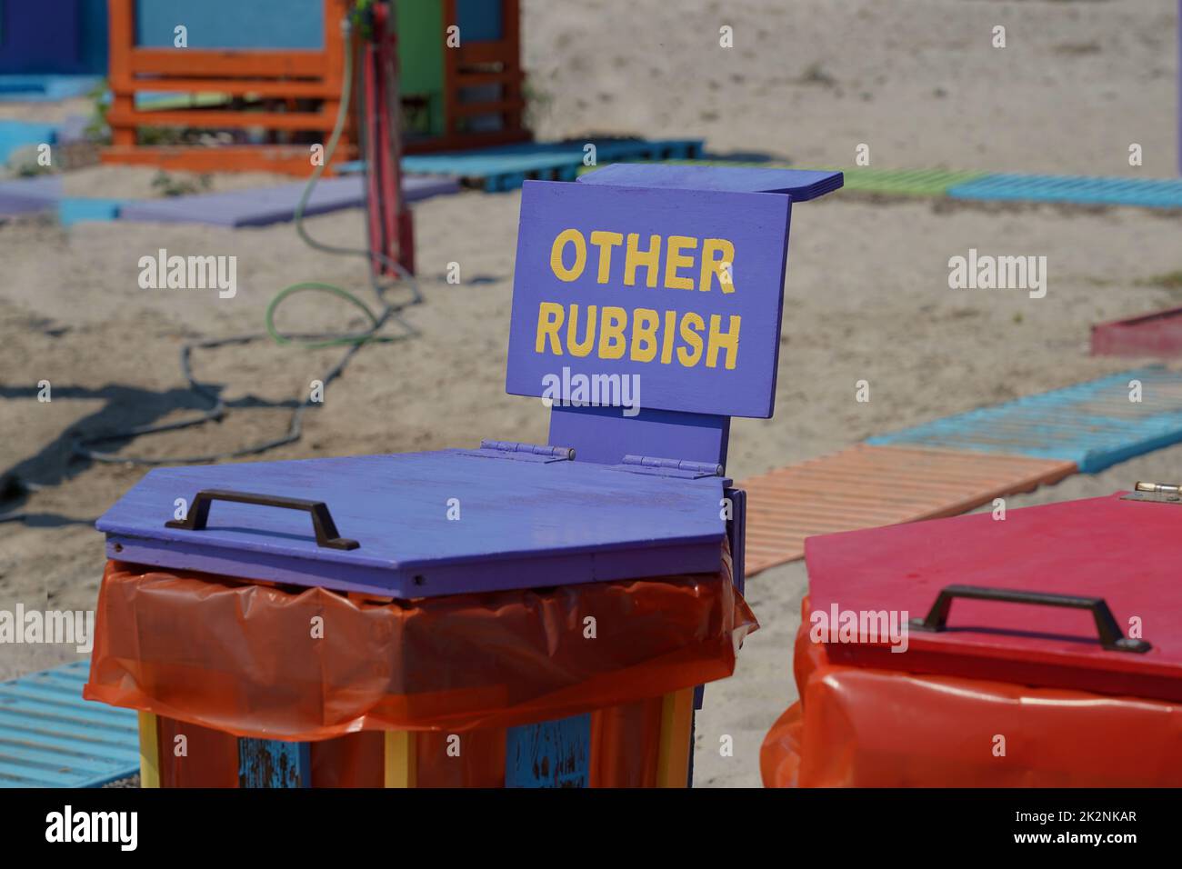 A garbage can for waste separation at the beach in Greece with label