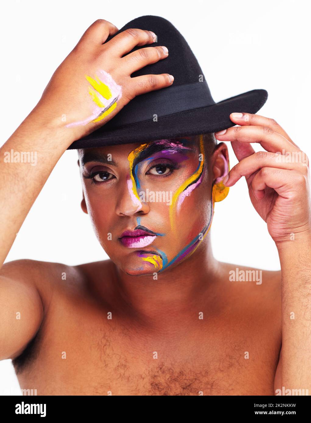 Ive got a hat full of tricks. Portrait of a gender fluid young man