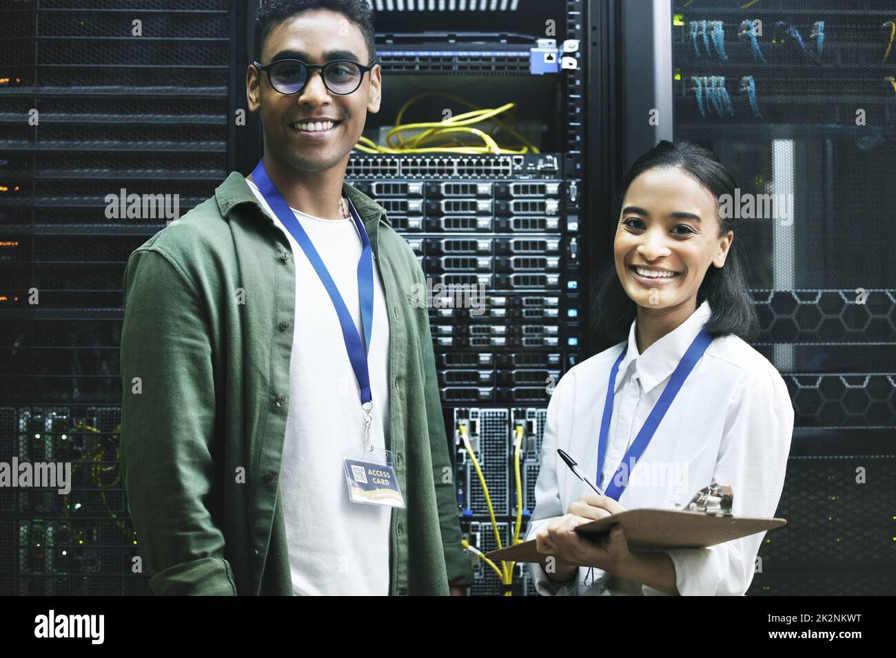 No virus, no problem. Shot of two technicians working together in a server room. Stock Photo