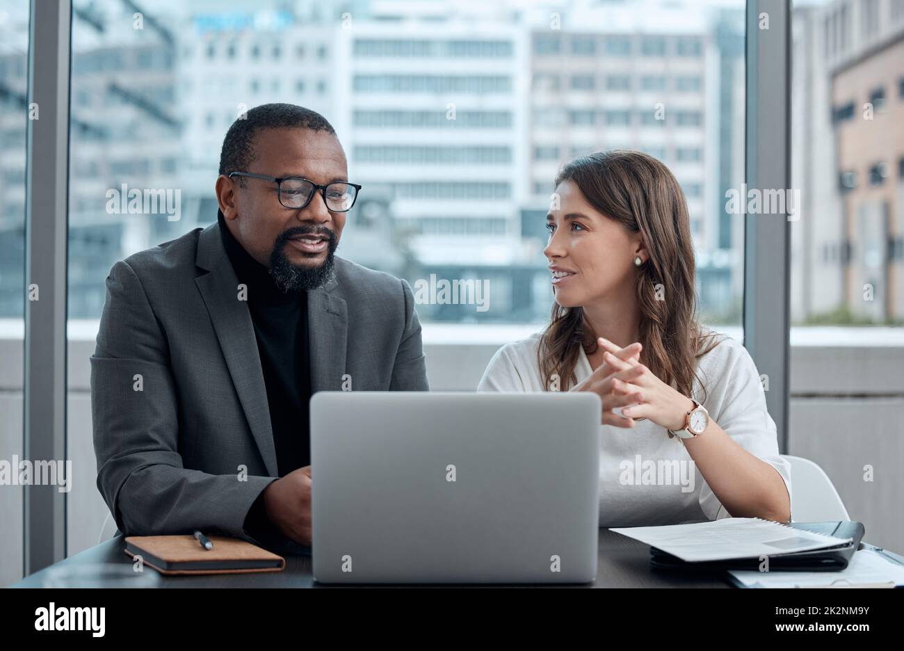 Learning from experience. Cropped shot of two corporate business colleagues having a meeting around the table in the boardroom. Stock Photo